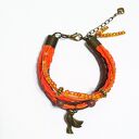 Pomarańczowa bransoletka z ptakiem handmade