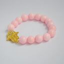 Bracelet by SIS: złota hamsa w jasno różowym marmurze