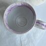 Kubek ceramiczny toczony na kole garncarskim. Pokryty białym i fioletowym szkliwem spożywczym. Do kawy