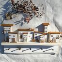 Wieszak ścienny z domkami w odcieniach bieli - rustykalna ozdoba z drewna