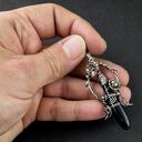 Czarny sztylet - srebrny wisior z onyksu w technice wire-wrapping